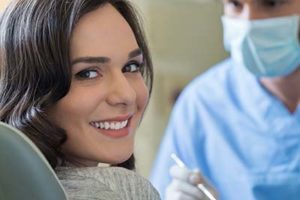 woman smiling in dentist chair, cosmetic dentistry conroe tx