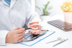 dentist working on a pair of full dentures