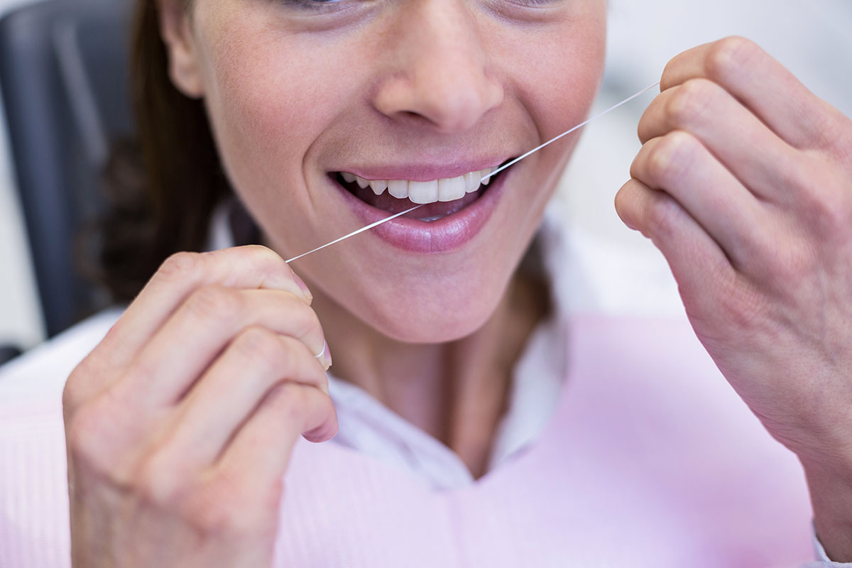 benefits of flossing daily woman experiencing benefits of flossing daily
