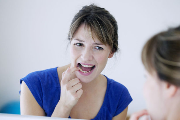 how does tooth decay develop woman wondering how does tooth decay develop