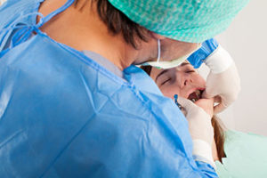 a dentist performing oral surgery