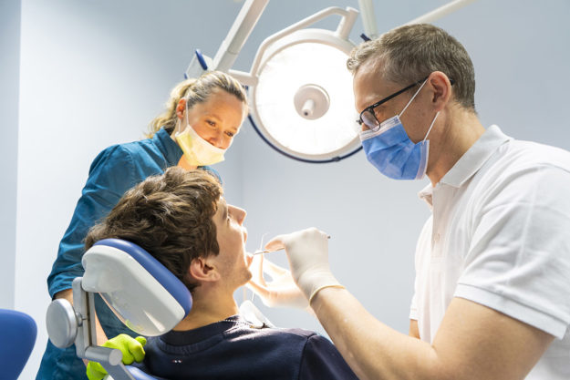 common dental problems dentist treating common dental problems in a patient