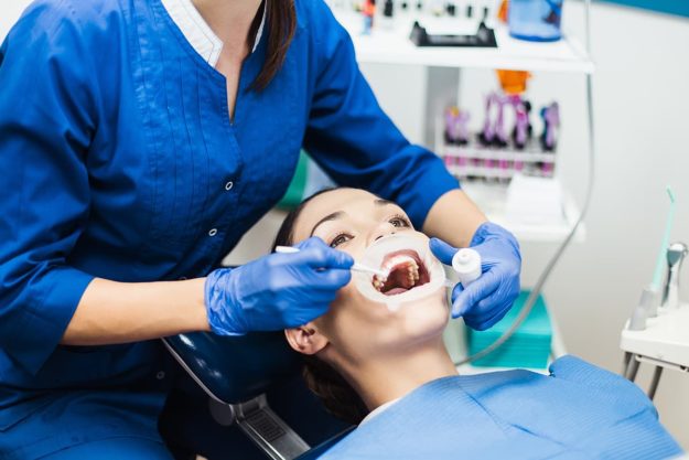 teeth whitening sensitivity patient getting treated with teeth whitening sensitivity