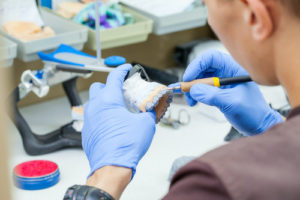 dentist making dental crowns and bridges