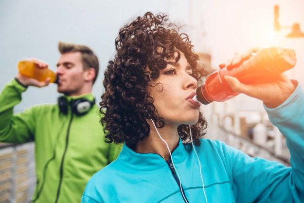 Energy Drinks And Your Teeth pair drinking energy drinks wondering about energy drinks and oral health