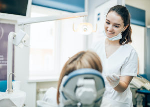 dentist performing a tooth extraction on a patient