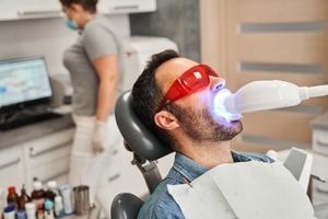 man getting teeth whitening services